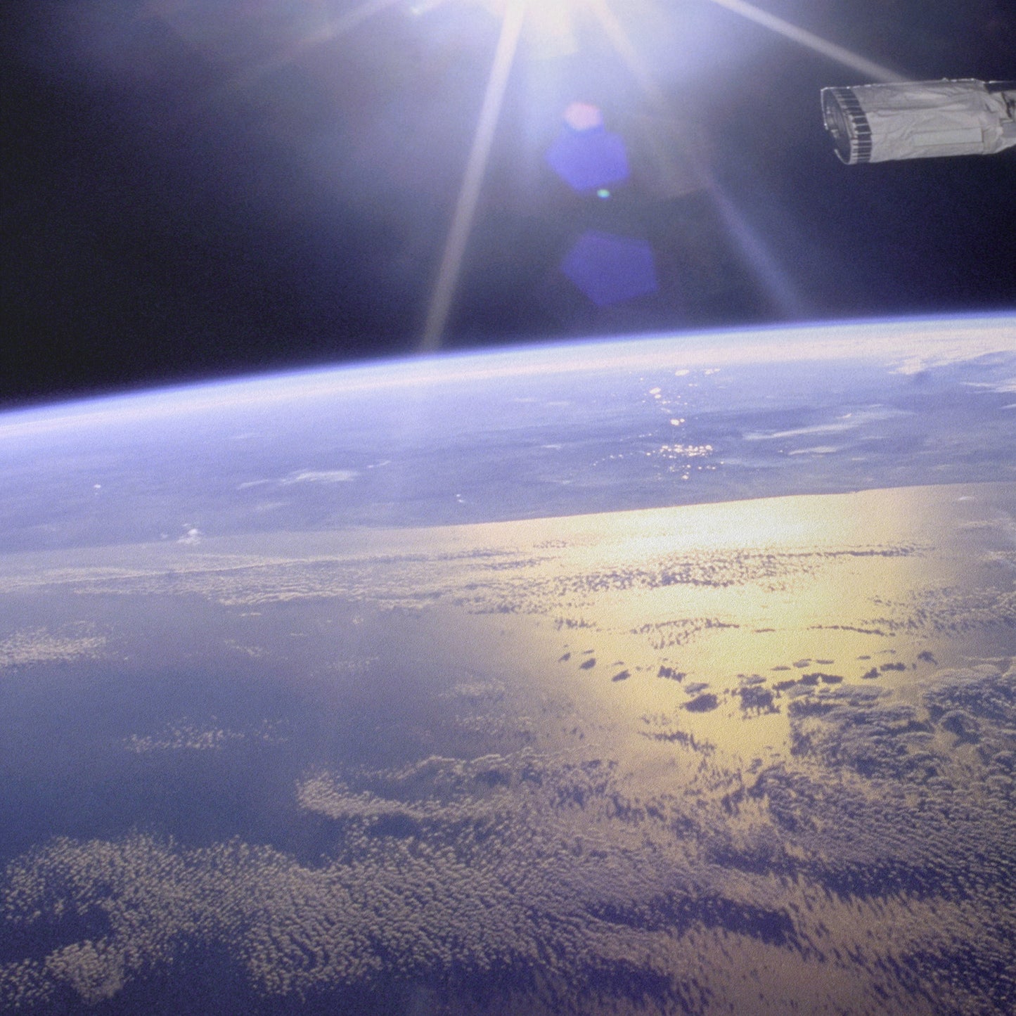 Robot Arm Over Earth with Sunburst